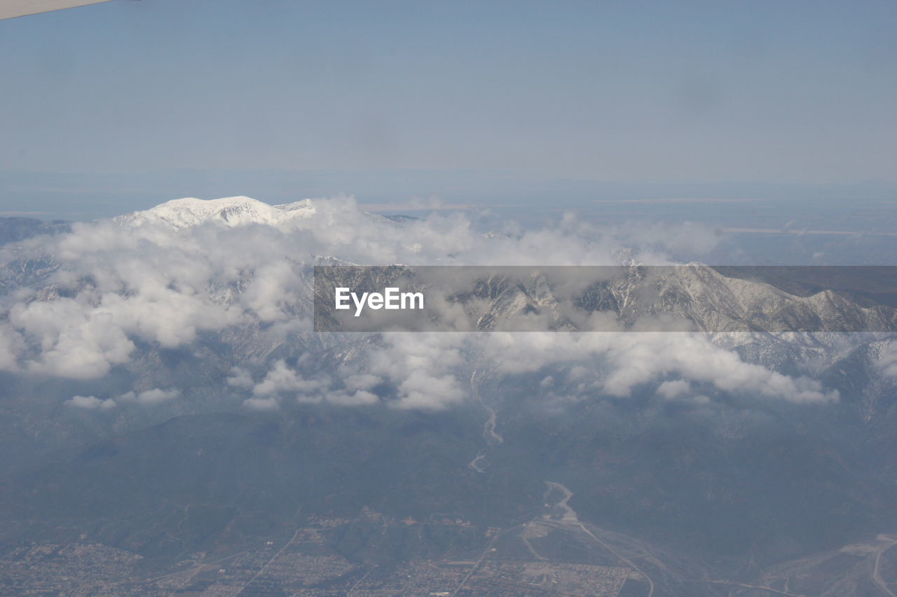 Aerial view of clouds over landscape against sky