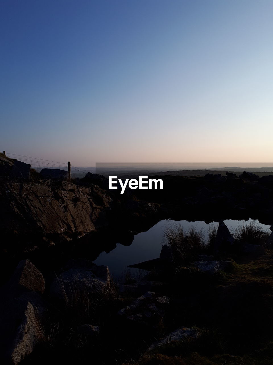 Scenic view of sea against clear sky at sunset