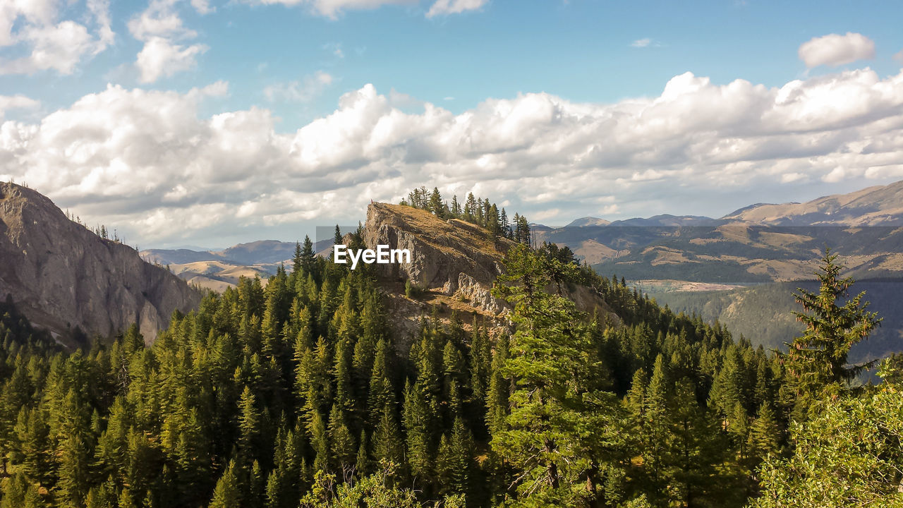 Scenic view of mountains against cloudy sky