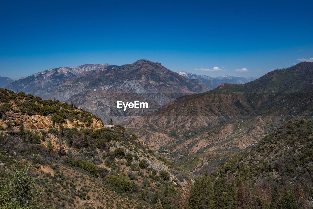 Scenic view of mountains against clear blue sky