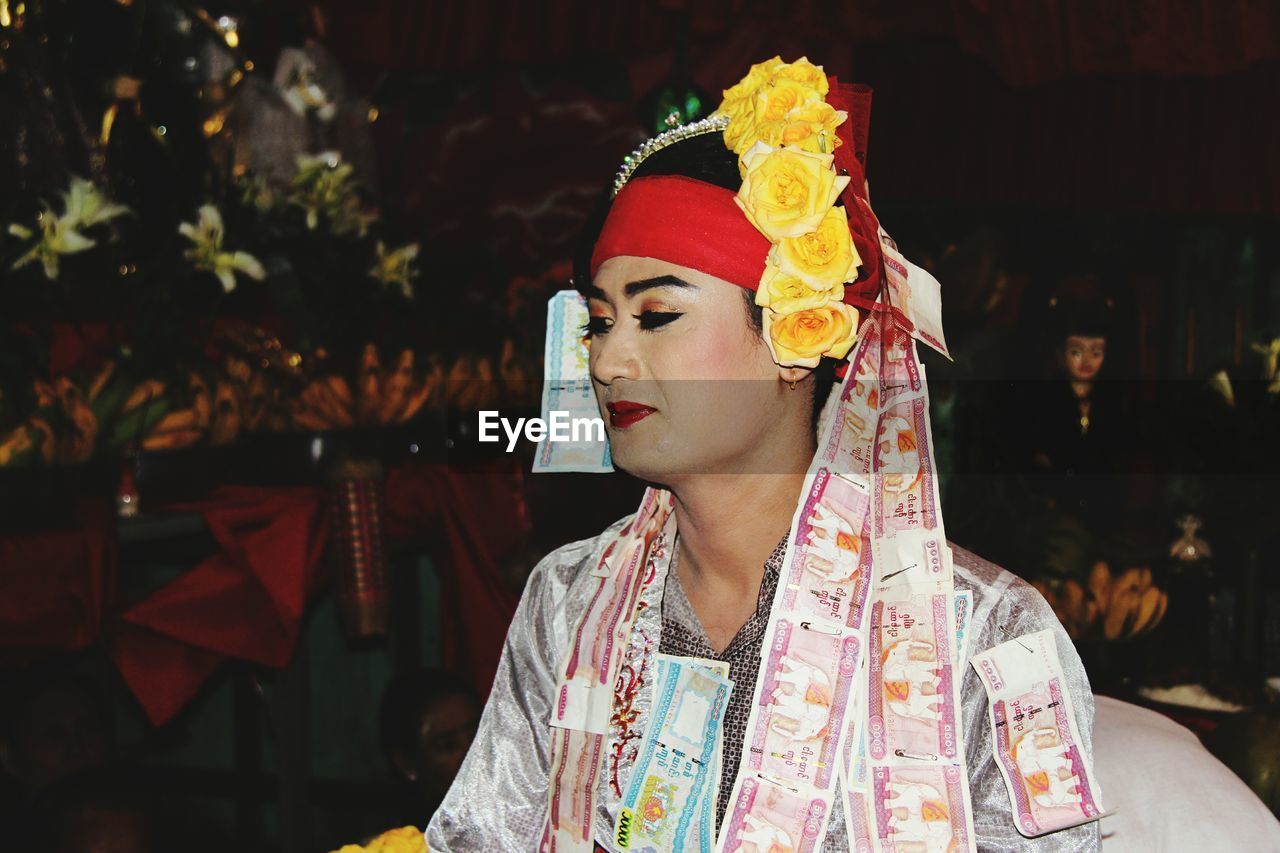 Close-up of man with make-up looking away