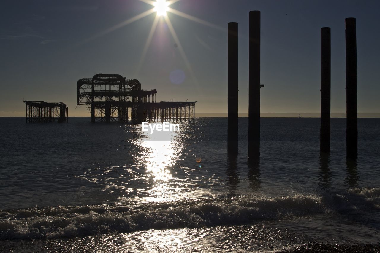 Abandoned palace pier in sea against sky