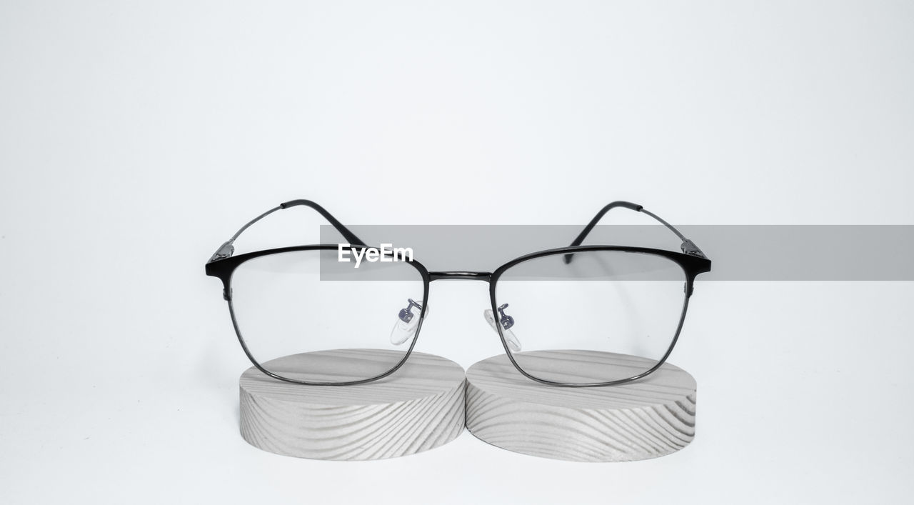 CLOSE-UP OF EYEGLASSES ON GLASS