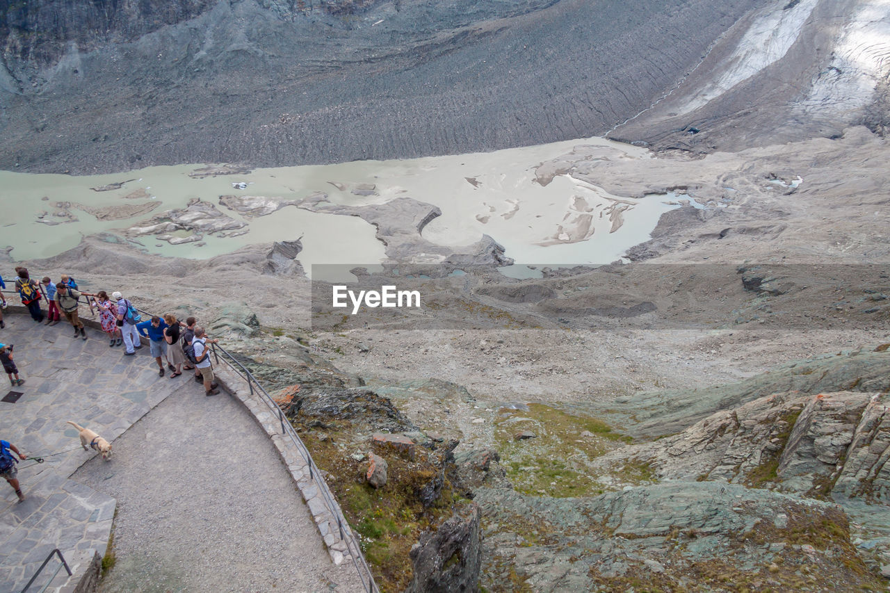 HIGH ANGLE VIEW OF PEOPLE WALKING ON MOUNTAIN