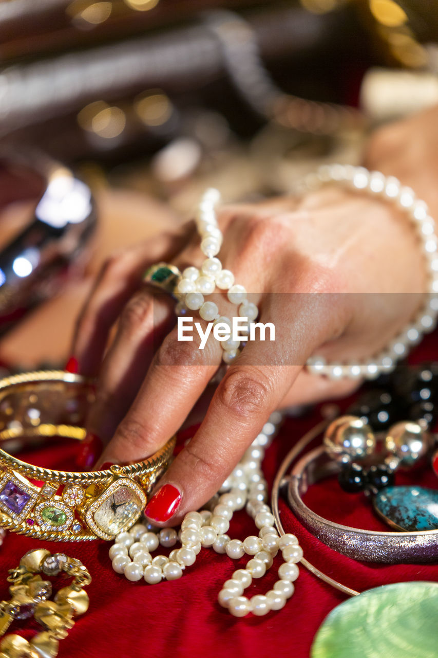 Cropped hand of woman touching jewelry