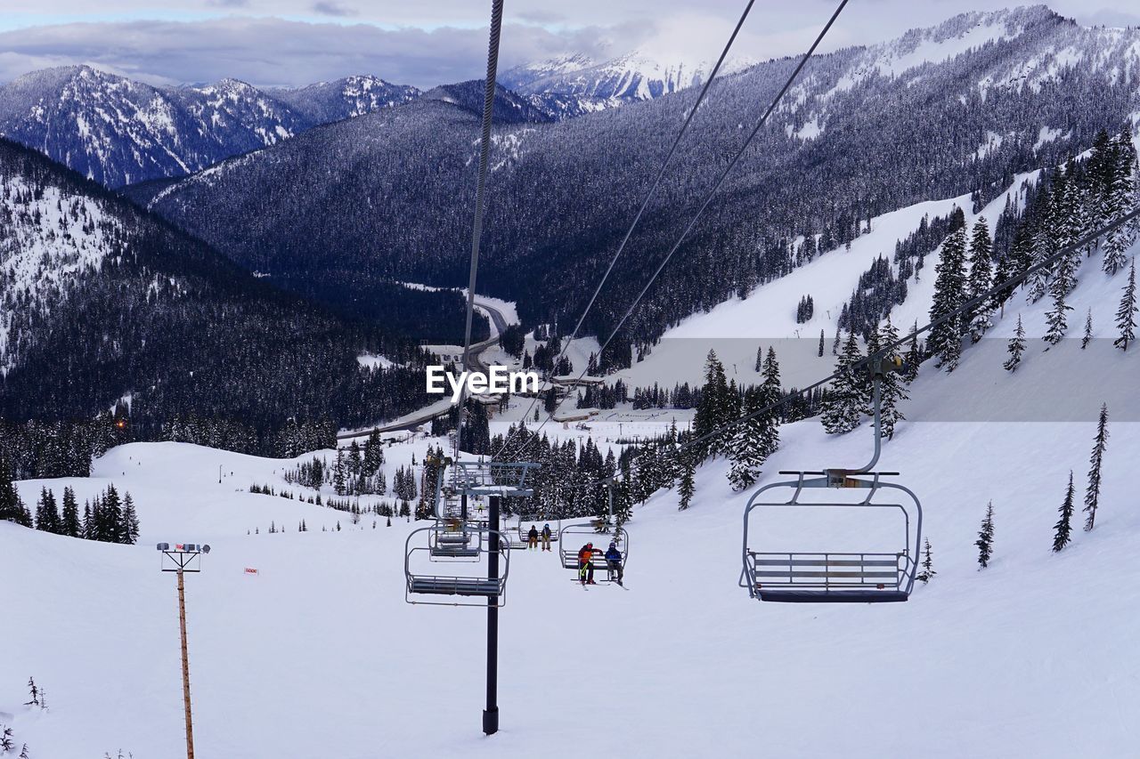 Ski lift over snow covered mountains