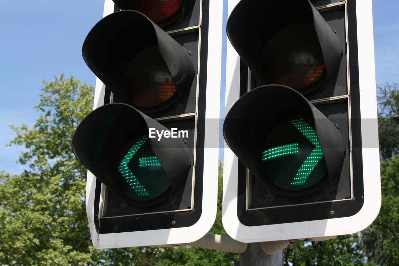 Low angle view of road signals against sky