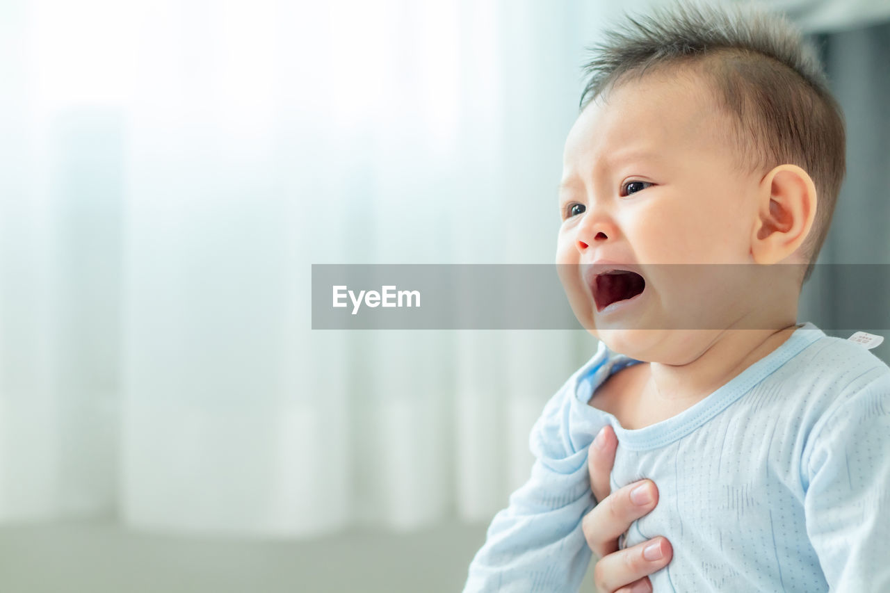 PORTRAIT OF CUTE BABY LOOKING AWAY