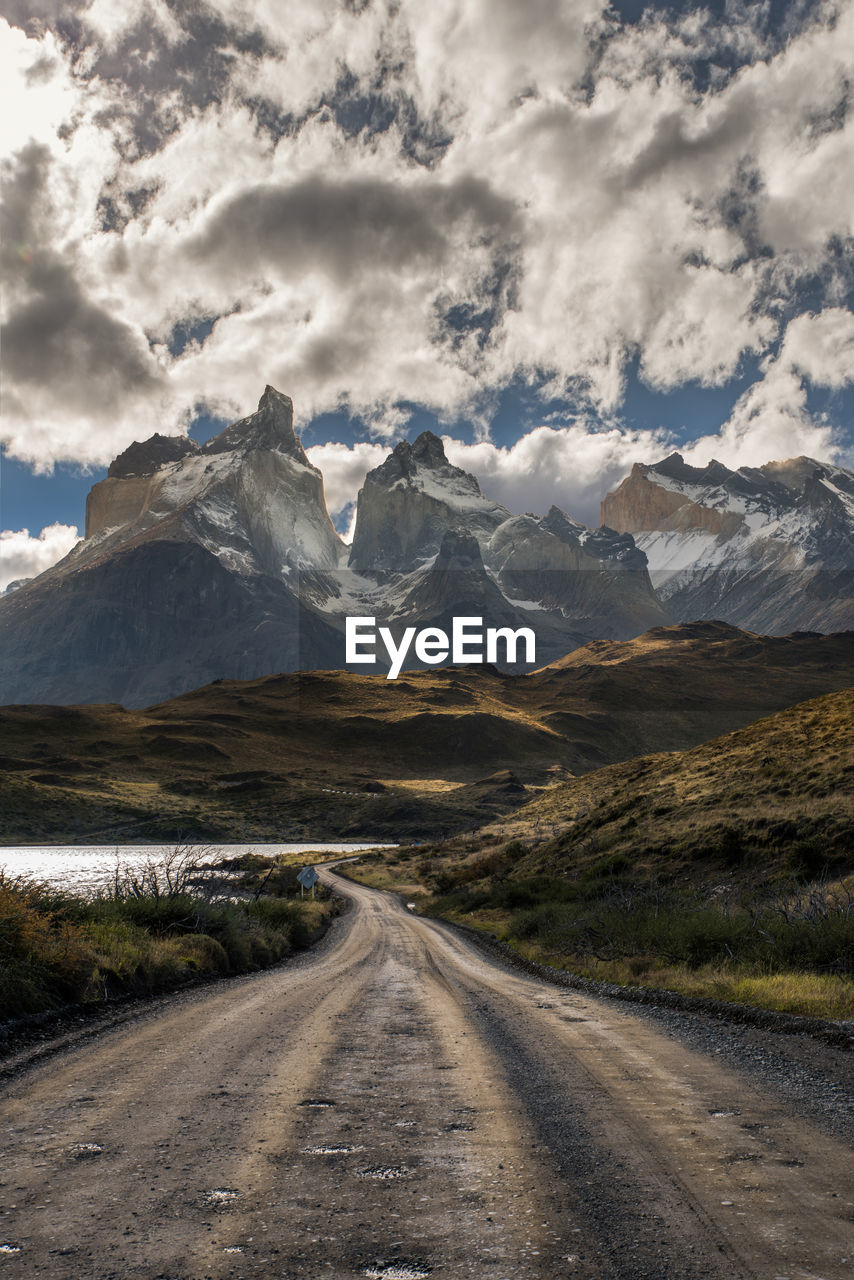 Road amidst mountains against sky