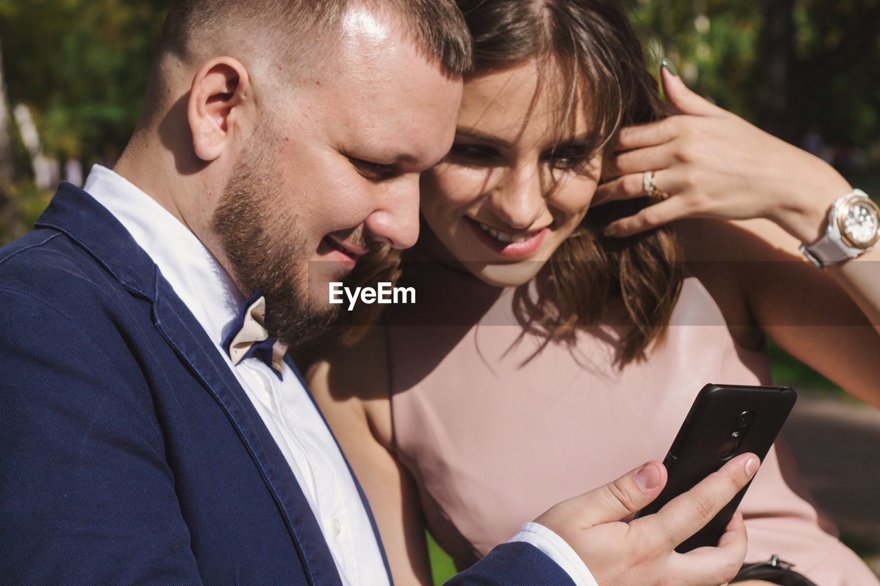 YOUNG WOMAN USING MOBILE PHONE