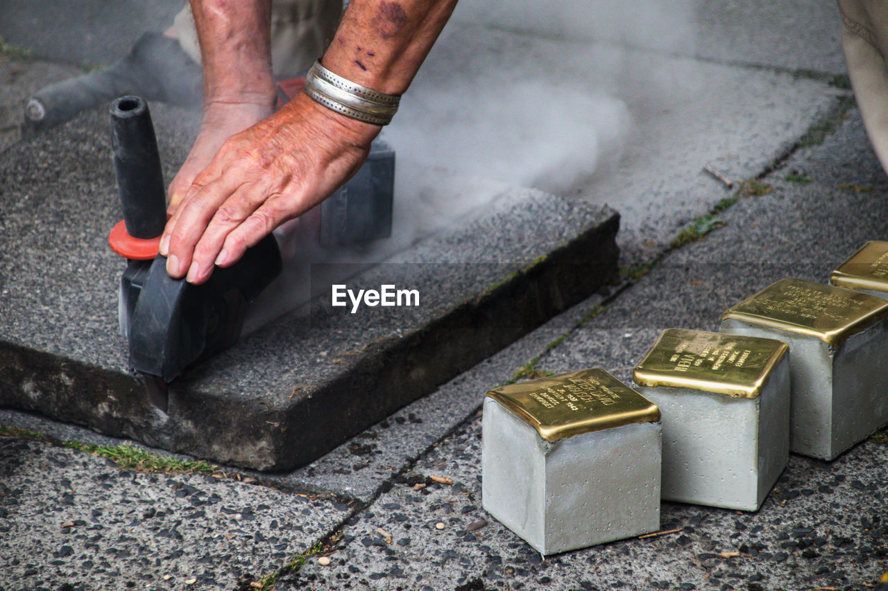 High angle view of man working on metal