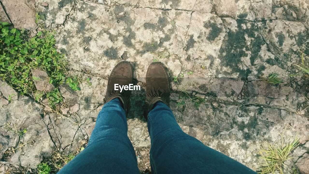 Low section of woman standing on street