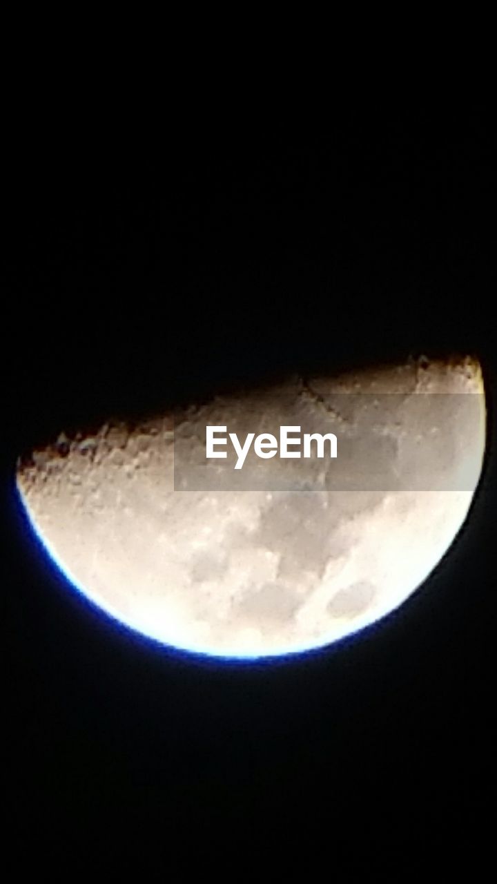 CLOSE-UP OF MOON OVER BLACK BACKGROUND