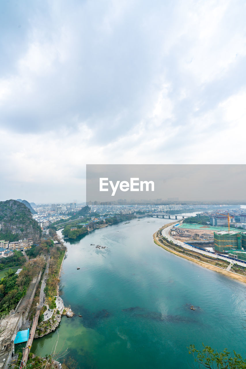 High angle view of sea and city against sky