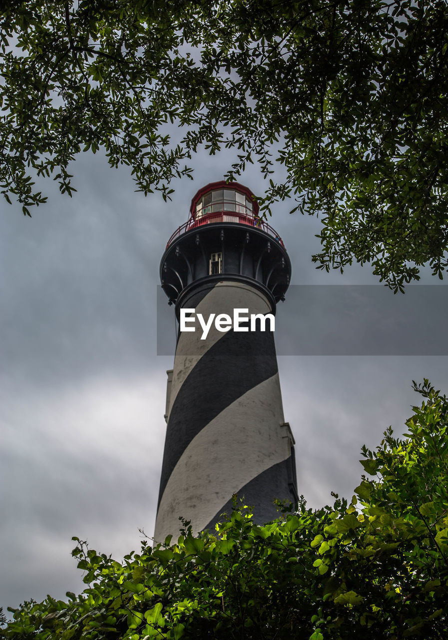 Low angle view of lighthouse against cloudy sky