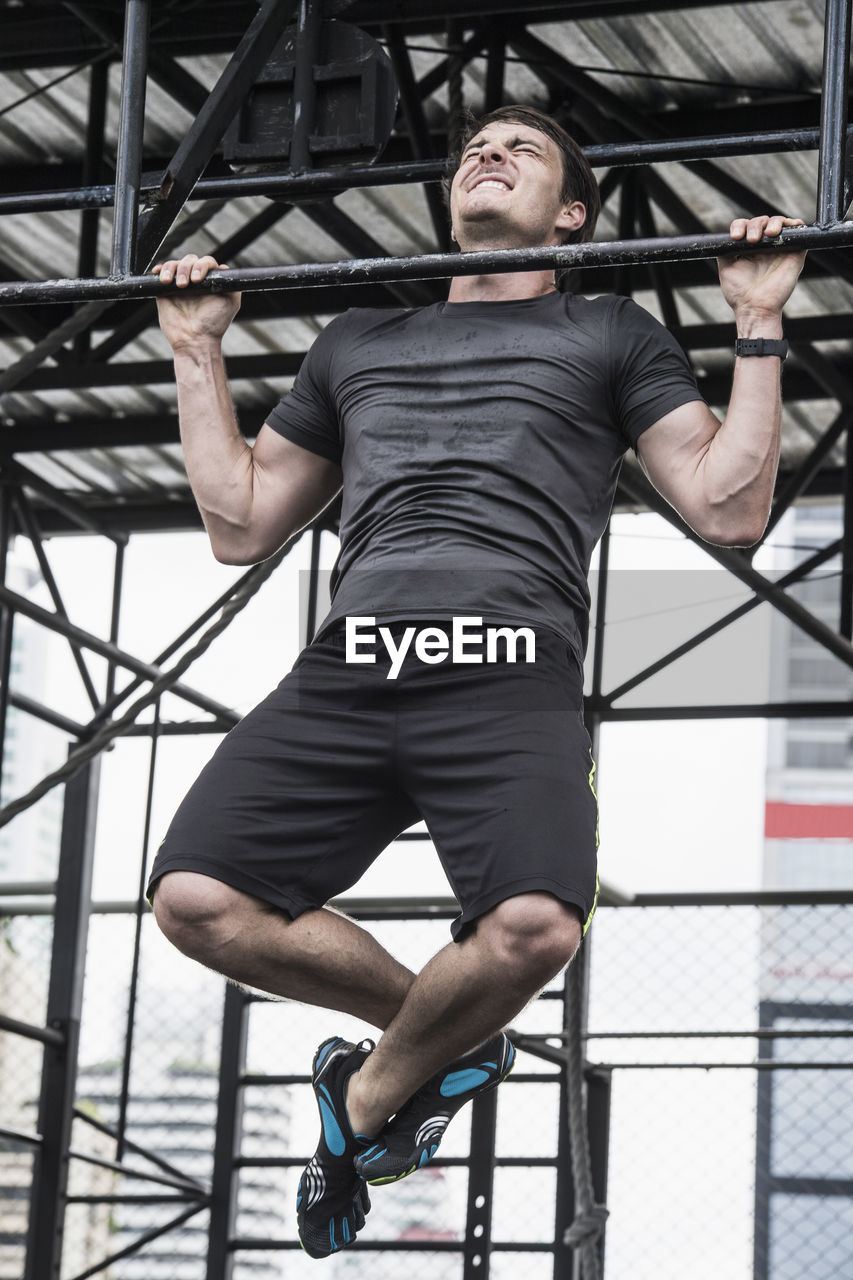 Man training at rooftop gym in bangkok