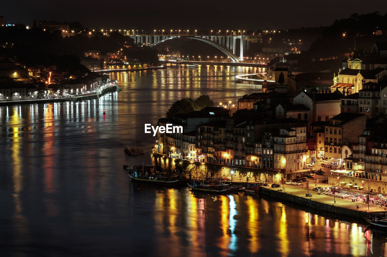 High angle view of illuminated city at waterfront