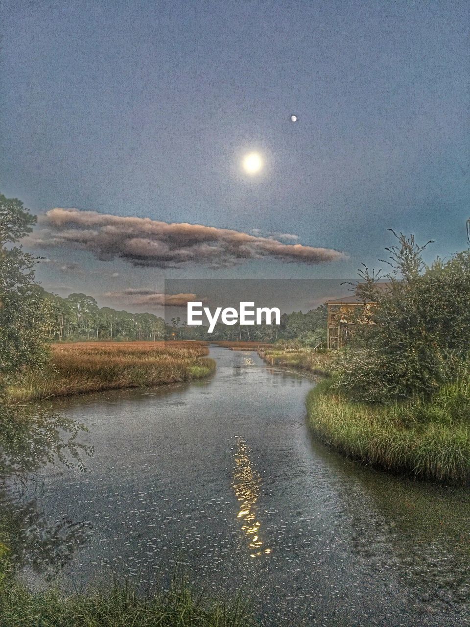 VIEW OF MOON OVER CALM SEA