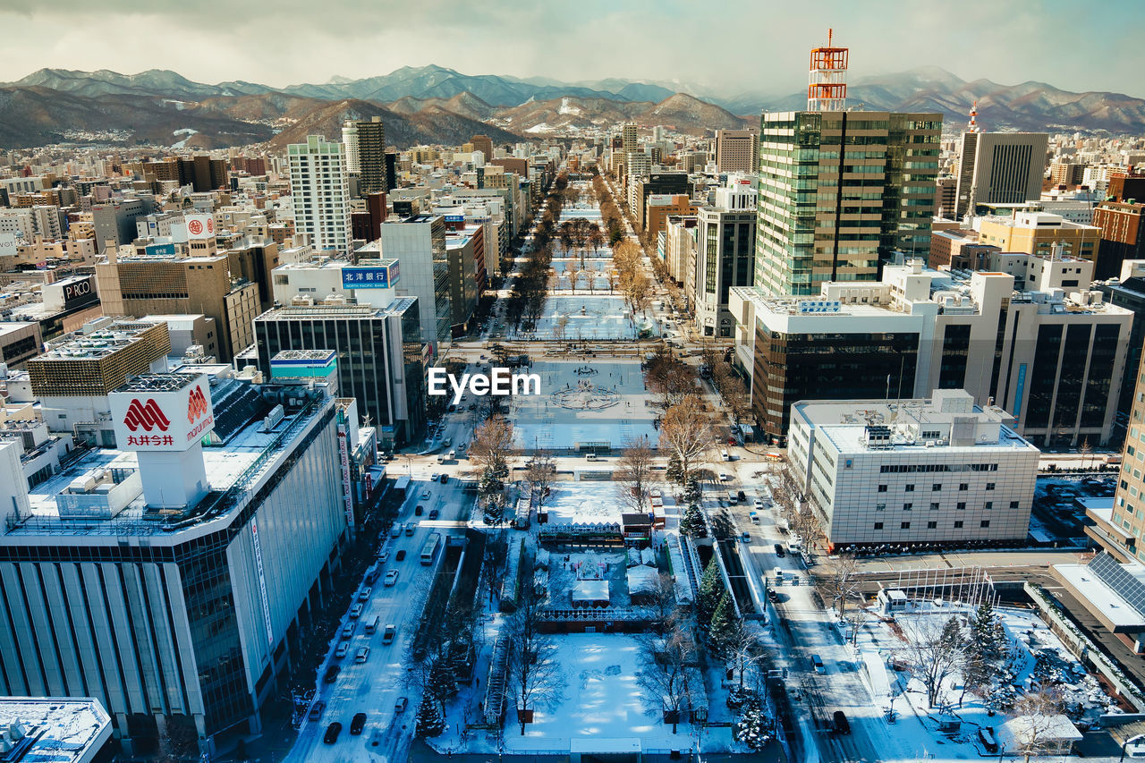 High angle view of modern buildings in city against sky