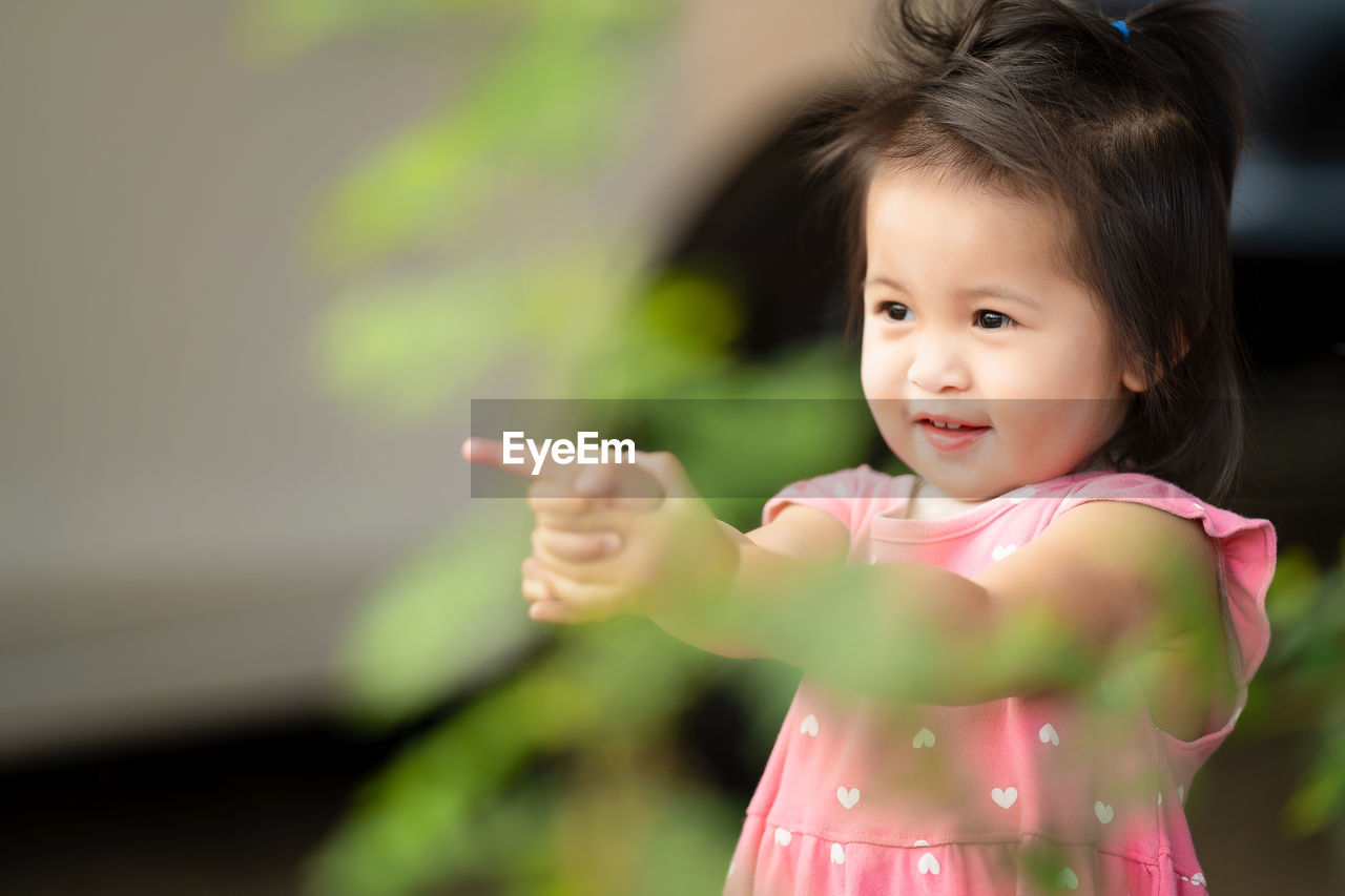 Little girl playing and smile in the park local thailand