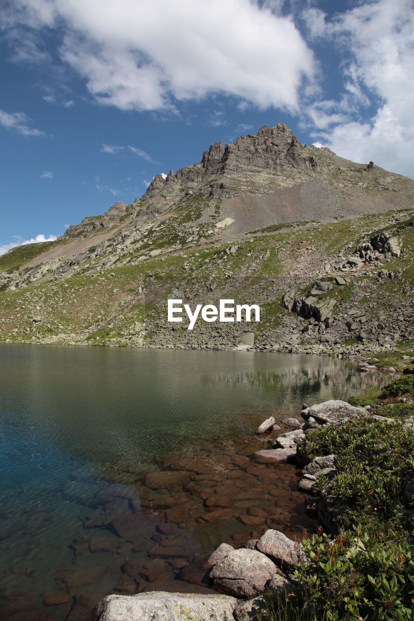 Scenic view of lake and mountains against sky