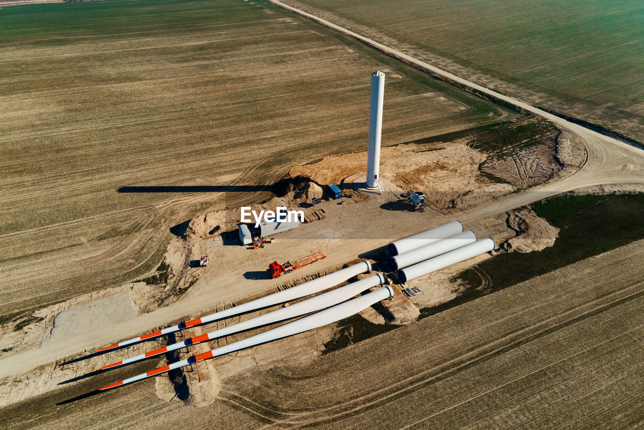Construction site with windmill turbine parts on ground