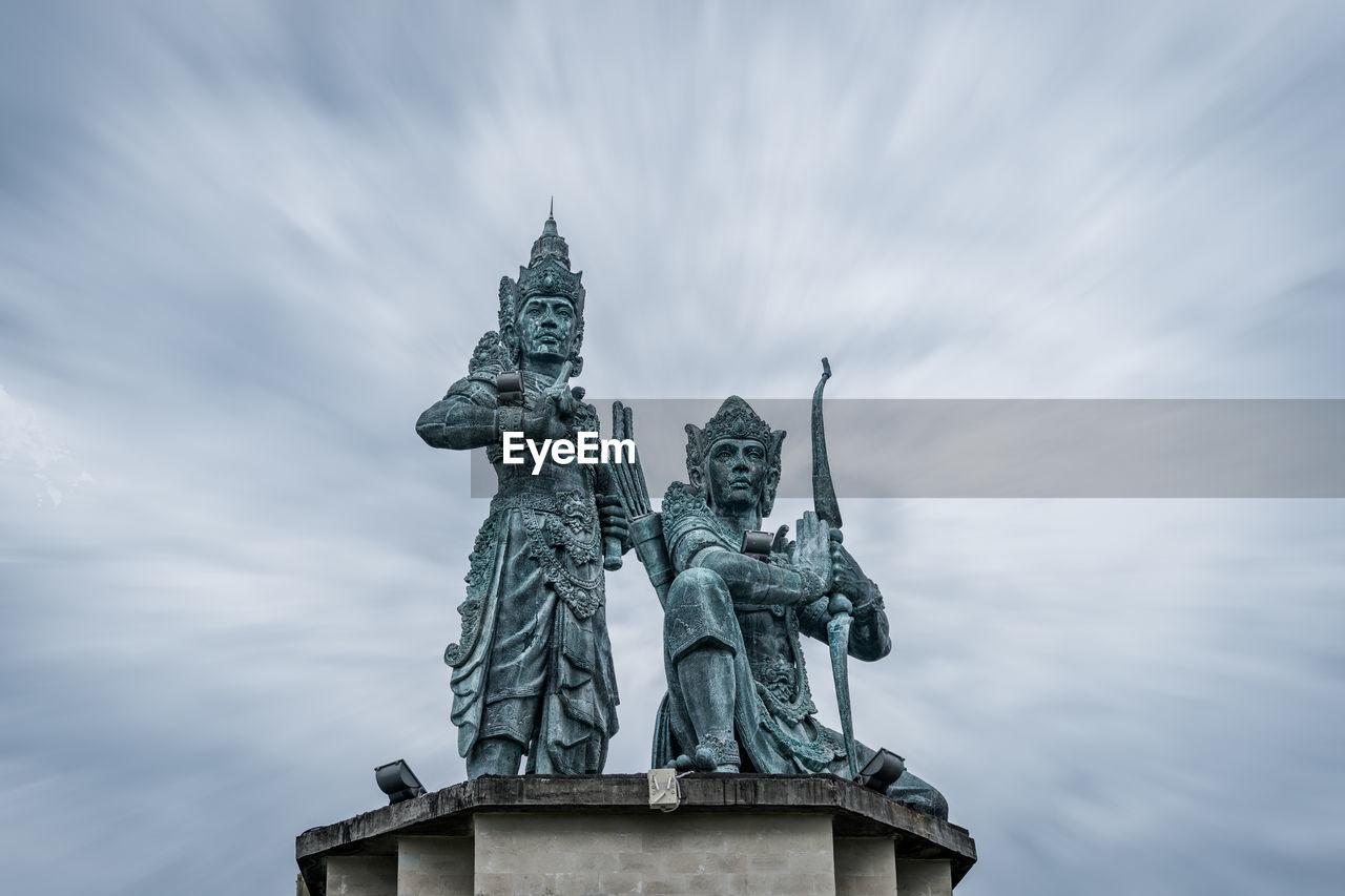 Low angle view of statue against cloudy sky