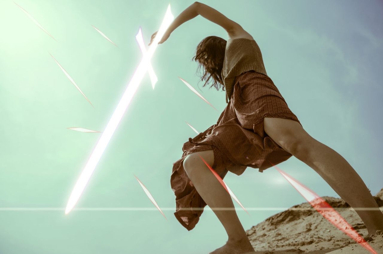 LOW ANGLE VIEW OF WOMAN AGAINST SKY