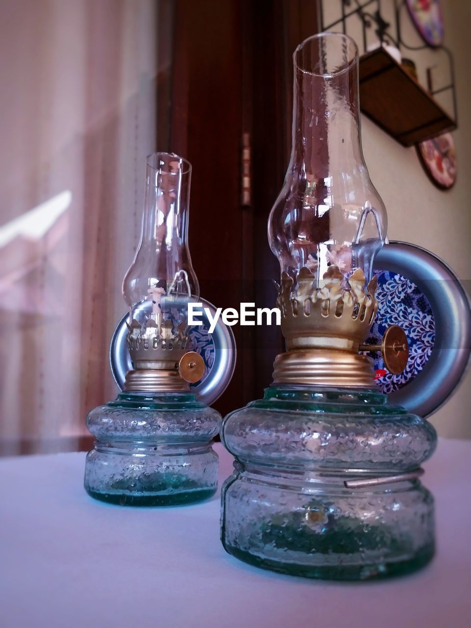 Close-up of oil lamps on table in room