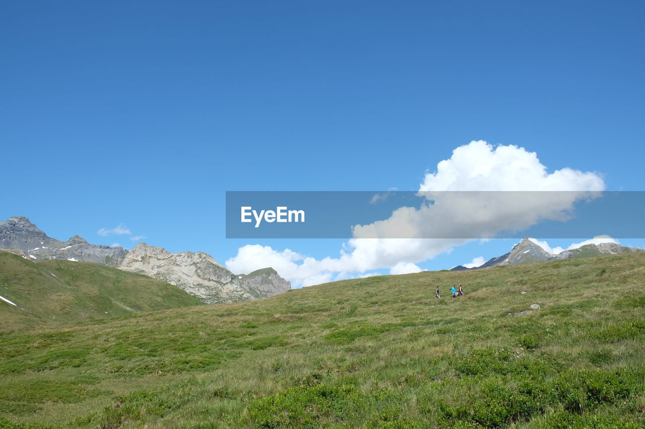 SCENIC VIEW OF MOUNTAINS AGAINST BLUE SKY