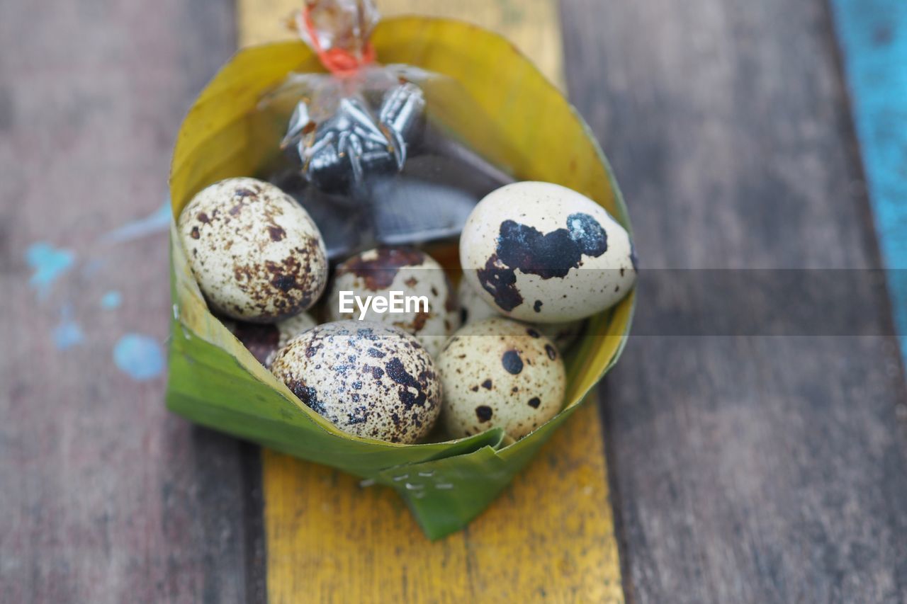 Close up quail eggs boiled eat with soya sauce in banana leaf bowl