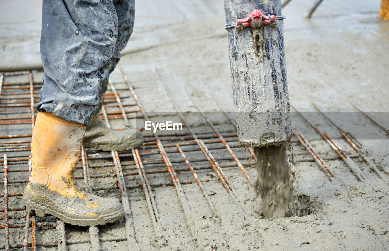 Low section of worker working at construction site