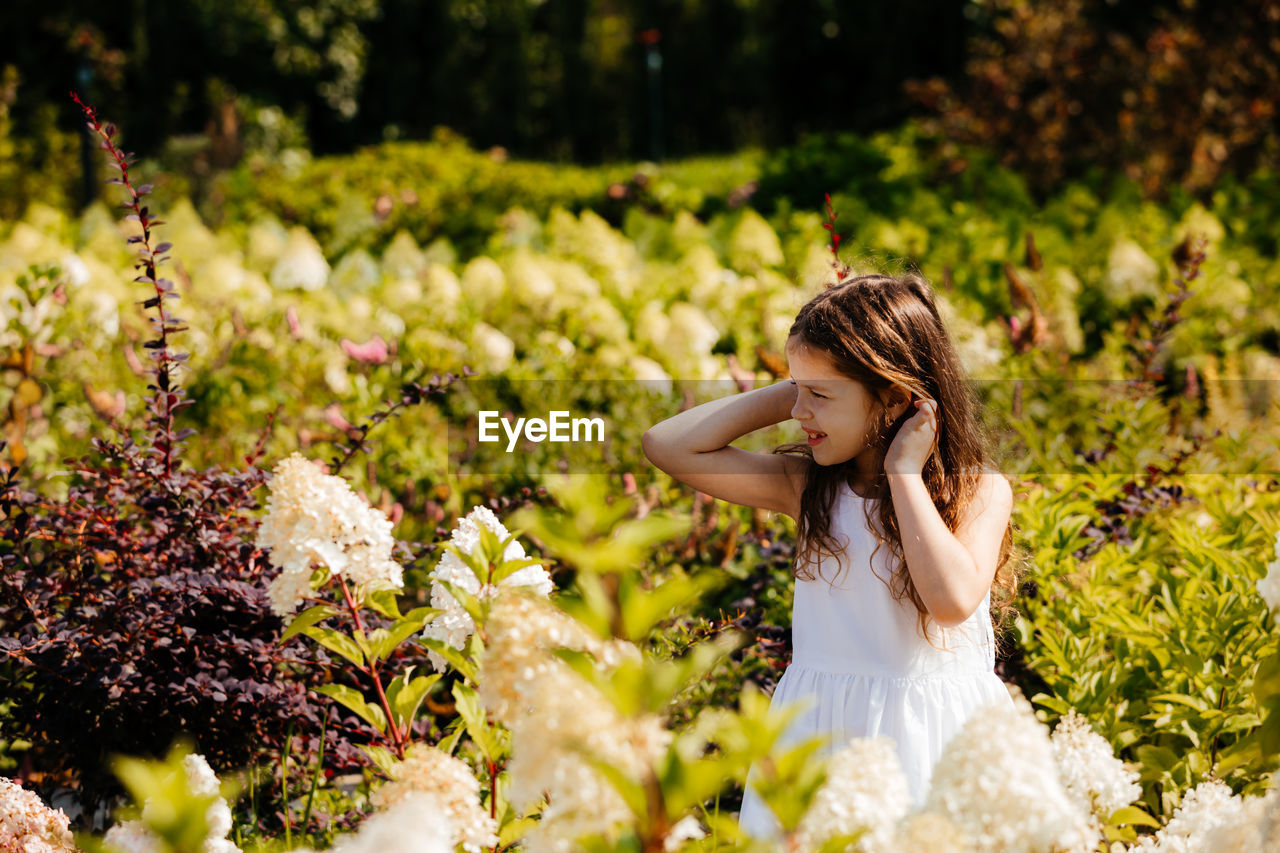 Cute girl sitting on plants