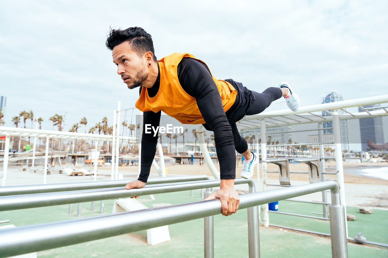 Low angle view of young man exercising in gym