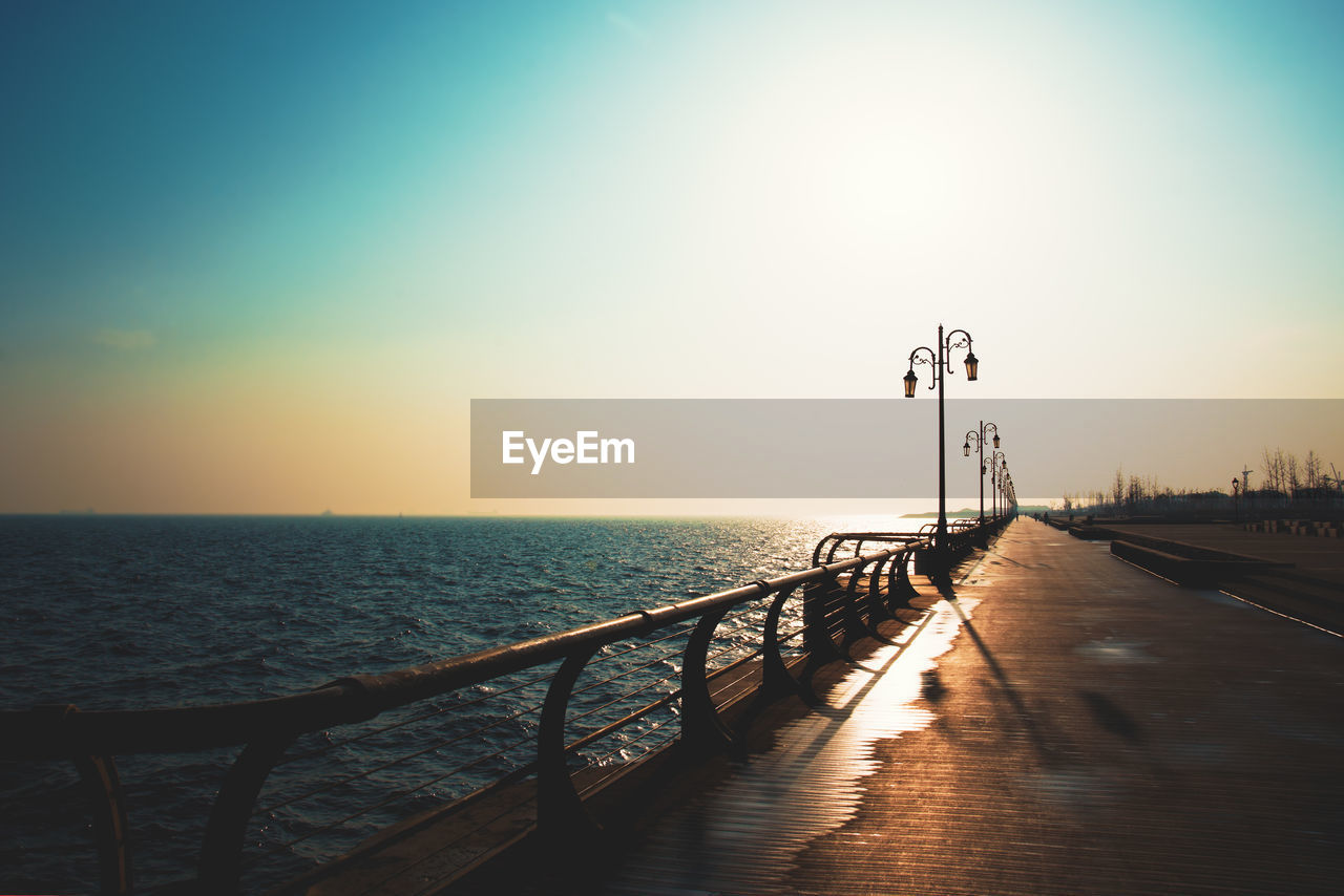 PIER ON SEA AGAINST SKY DURING SUNSET