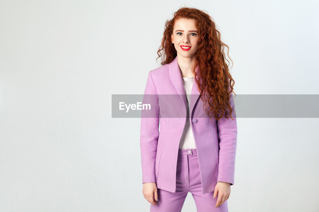 Portrait of beautiful young woman over white background