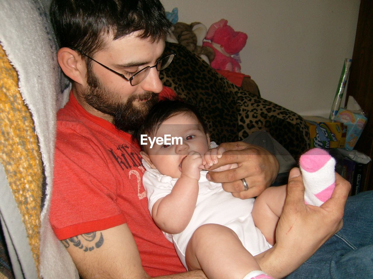 Father with baby sitting at home