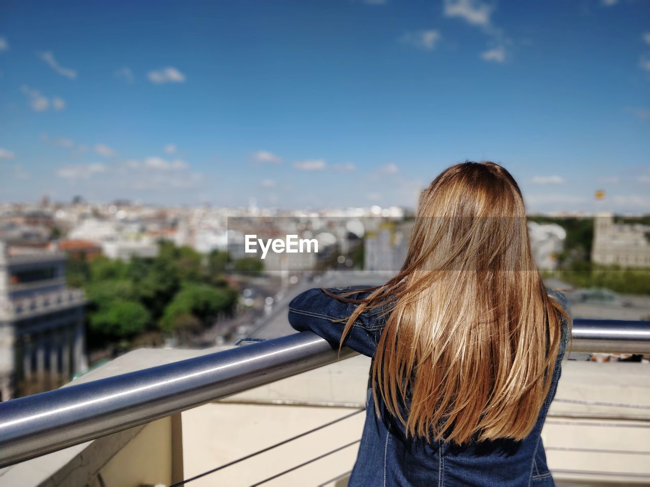 Rear view of woman looking at cityscape