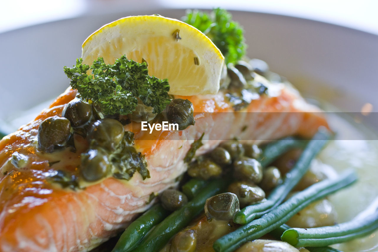 Close up of salmon with capers and lemon