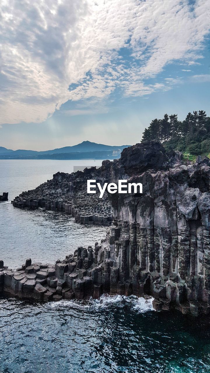 SCENIC VIEW OF SEA AGAINST ROCK FORMATION