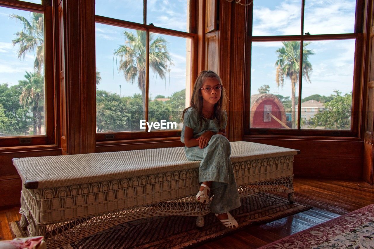 Portrait of girl sitting by the window