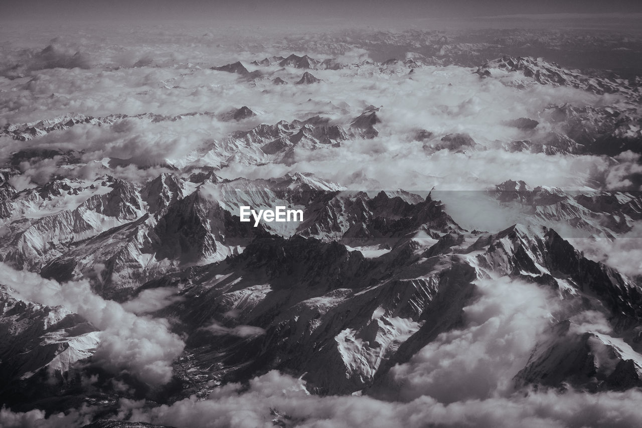 Aerial view of snowcapped mountain against sky