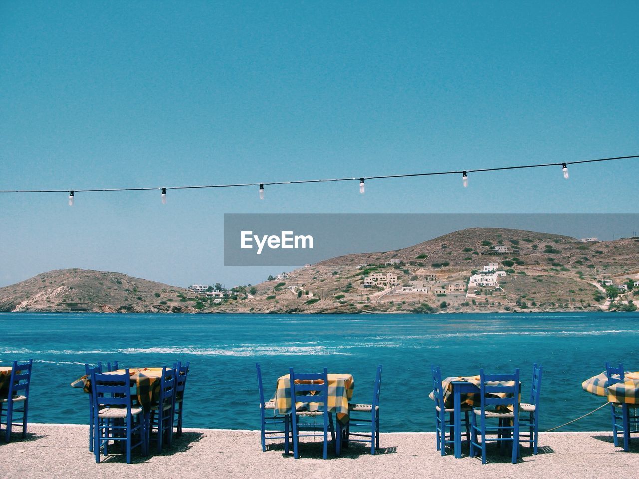 CHAIRS ON BEACH AGAINST CLEAR SKY