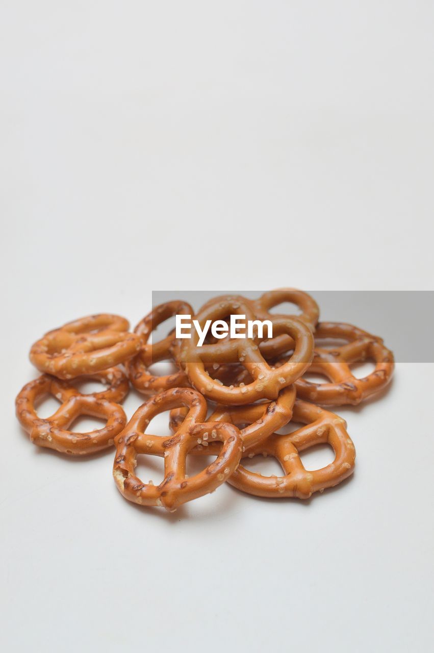 Close-up of pretzel over white background