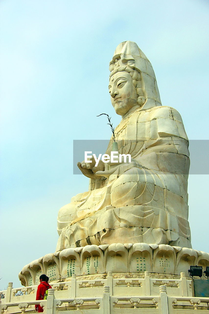 Low angle view of statue against clear blue sky