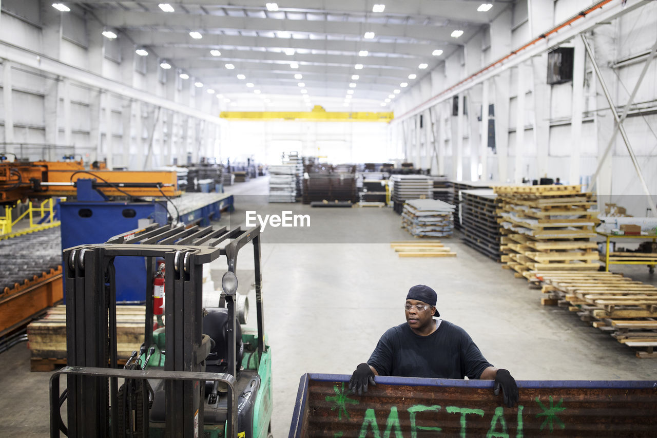 High angle view of worker working in steel industry factory