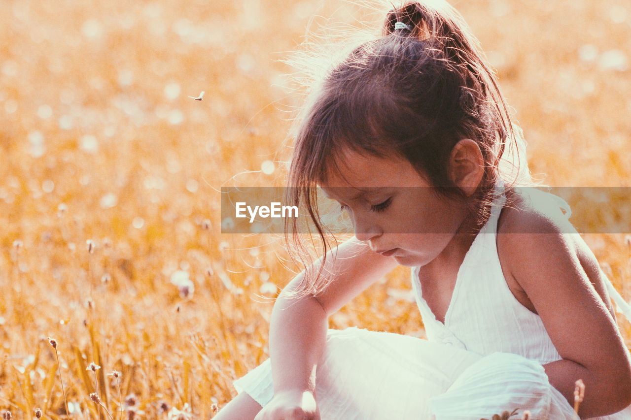 Girl sitting on field