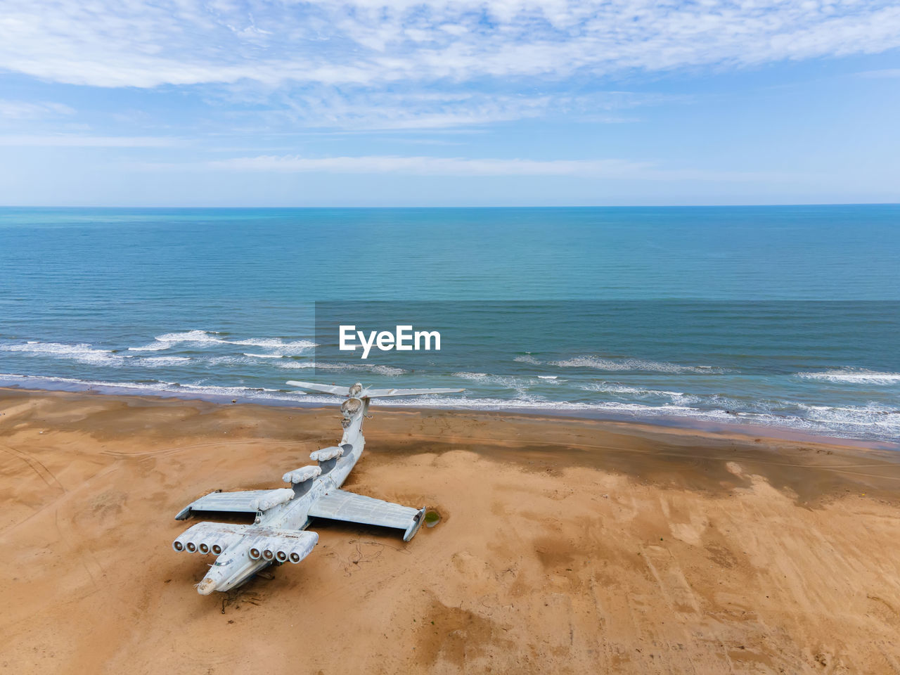 Military abandoned lun plane stands on a beach in dagestan