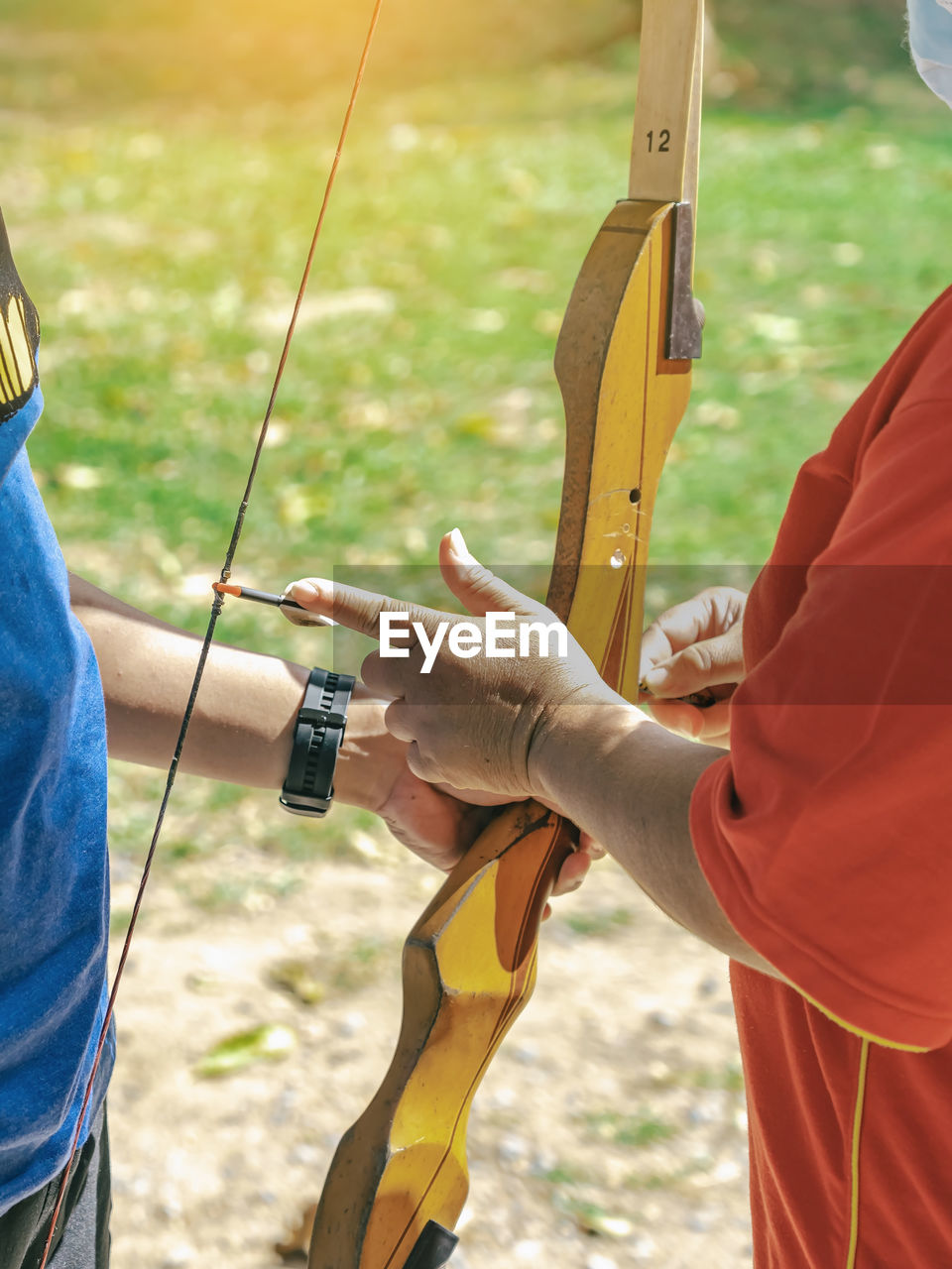 recreation, adult, bow and arrow, leisure activity, activity, men, nature, holding, sports, two people, archery, day, lifestyles, casting, outdoors, longbow, focus on foreground, person, land, adventure, hand