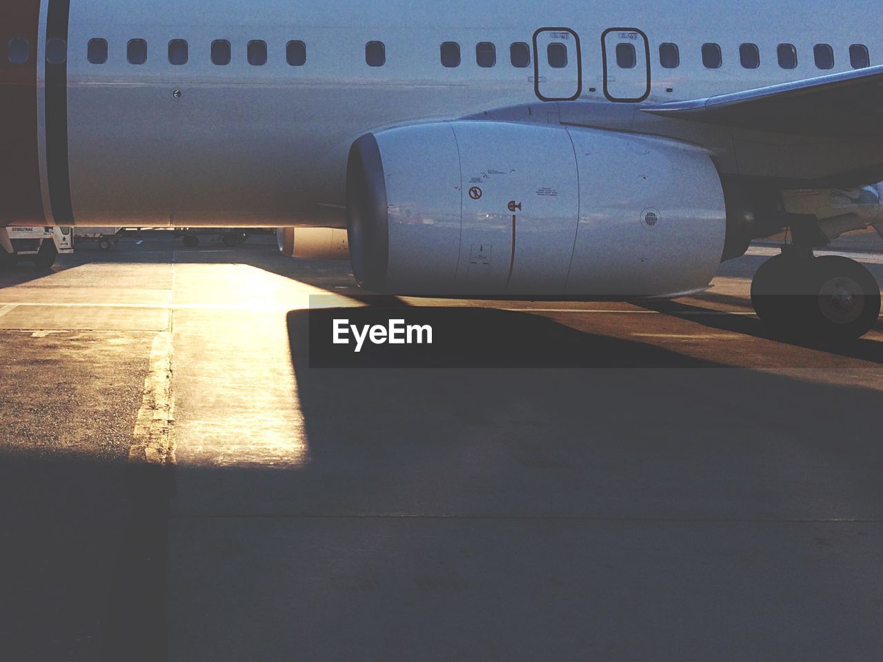 Cropped image of airplane on runway with sunlight at stockholm arlanda airport